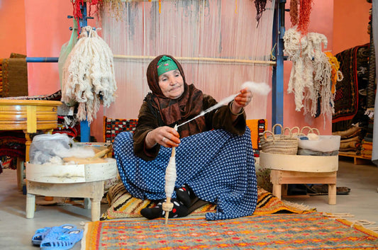 Moroccan women hand crafting rug